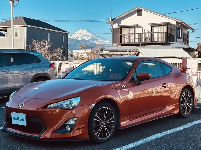 トヨタ ８６ GT 静岡県 2012(平24)年 9.5万km オレンジメタリック ユーザー買取車両/純正HDDナビ（NHZA-W61G）/【AM/FM/CD/BT/TV】/純正17インチAW/MTモード付AT/パドルシフト/スマートキー/エンジンスタートボタン/バックカメラ/ETC/レザーシート/純正エアロパーツ（フロント、サイド、リア）/横滑り防止装置/ドライブレコーダー/保証書/取扱説明書