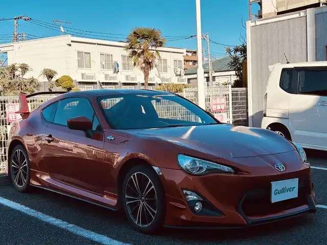トヨタ ８６ GT 静岡県 2012(平24)年 9.5万km オレンジメタリック ユーザー買取車両/純正HDDナビ（NHZA-W61G）/【AM/FM/CD/BT/TV】/純正17インチAW/MTモード付AT/パドルシフト/スマートキー/エンジンスタートボタン/バックカメラ/ETC/レザーシート/純正エアロパーツ（フロント、サイド、リア）/横滑り防止装置/ドライブレコーダー/保証書/取扱説明書