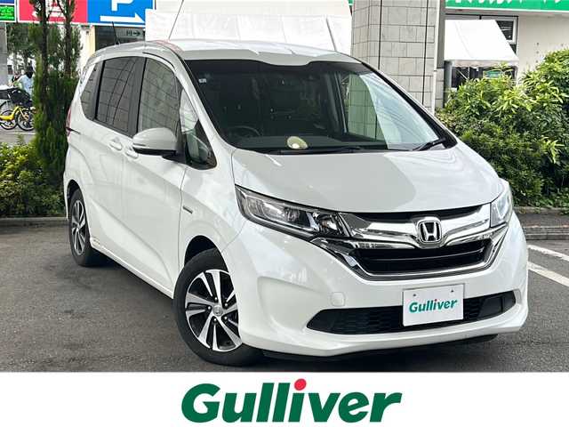 ホンダ フリード ハイブリット EX 東京都 2018(平30)年 6.7万km ホワイトオーキッドパール ワンオーナー/Panasonicポータブルナビゲーション（Bluetooth接続、フルセグテレビ）/カロッツェリア後席モニター/スマートキー/バックカメラ/ビルトインETC/三列シート/ウォークスルー/純正フロアマット/クルーズコントロール/プッシュスタート/ABS/横滑り防止機能/レーンキープアシスト/オートライト/スペアキー/ハーフレザーシート