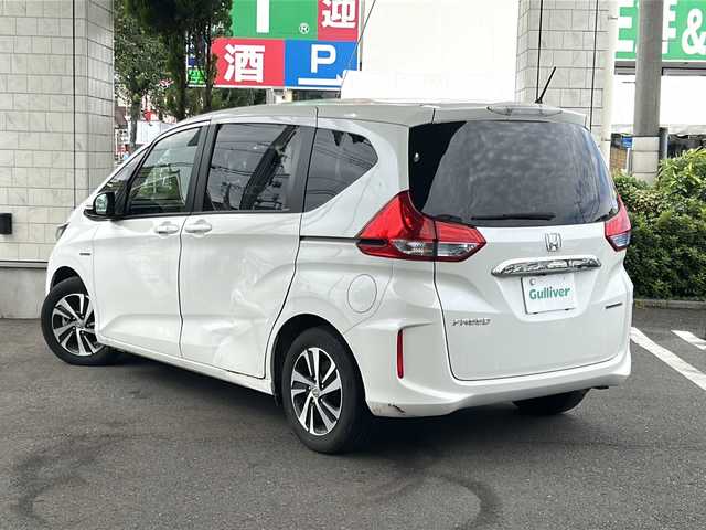 ホンダ フリード ハイブリット EX 東京都 2018(平30)年 6.7万km ホワイトオーキッドパール ワンオーナー/Panasonicポータブルナビゲーション（Bluetooth接続、フルセグテレビ）/カロッツェリア後席モニター/スマートキー/バックカメラ/ビルトインETC/三列シート/ウォークスルー/純正フロアマット/クルーズコントロール/プッシュスタート/ABS/横滑り防止機能/レーンキープアシスト/オートライト/スペアキー/ハーフレザーシート
