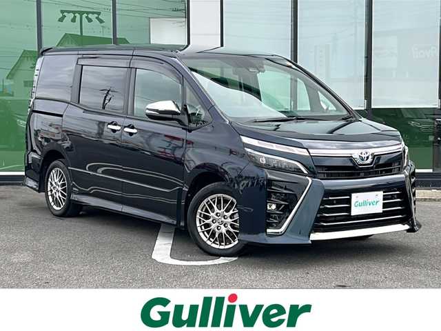 トヨタ ヴォクシー ハイブリッド ZS 煌Ⅲ 岐阜県 2021(令3)年 5.9万km ブラッキッシュアゲハガラスフレーク 登録時走行距離58535km/純正10インチナビ/バックモニター/後席モニター/フルセグテレビ/12インチ後席モニター/シートヒーター/クルーズコントロール/両側パワースライドドア/ETC2.0/フォグランプ/純正アルミホイール/オートライト/オートマチックハイビーム/レーンキープアシスト/LEDヘッドライト/純正フロアマット/スマートキー/プッシュスタート/ドアバイザー/禁煙車