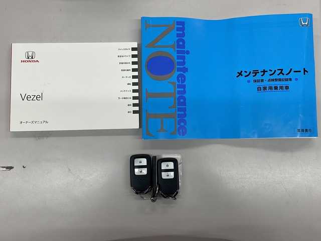 ホンダ ヴェゼル 愛知県 2016(平28)年 5.1万km ホワイトオーキッドパール /ワンオーナー//禁煙車//Bluetooth・FM・AM・//フルセグテレビ//純正ディーラーナビ//バックカメラ//後席会話サポート//クルーズコントロール//ETC//保証書//取扱説明書//記録簿//スペアキー（1本）//スマートキー//電動格納ミラー//オートライト//ハロゲンフォグランプ//純正16インチアルミホイール//ABS//TCS//横滑り防止//Gマット//ISOFIX//ブレーキホールド//ブレーキアシスト//衝突安全ボディー//EBD//盗難防止システム//UVカットガラス//プライバシーガラス//プッシュスタート//革巻きステアリング