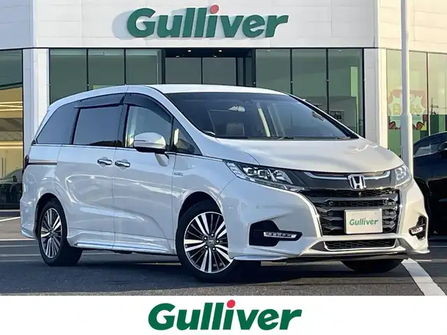 ホンダ オデッセイ ハイブリッド アブソルート・EXホンダセンジング 島根県 2020(令2)年 8.1万km プラチナホワイトパール 登録時走行距離80710km/取説/ナビ説/ホンダインターナビシステム/純正9インチナビ(VXM-207VFNI)/・フルセグTV/AM/FM/CD/DVD/Bluetooth/Honda SENSING(後期)/・衝突軽減ブレーキ/・誤発進抑制機能/・後方誤発進抑制機能/・歩行者事故低減ステアリング/・渋滞追従機能付きアダプティブクルーズコントロール/・車線維持支援システム/・路外逸脱抑制機能/・先行車発進お知らせ機能/・標識認識機能/マルチビューカメラシステム(全方位)/両側パワースライドドア/オットマン/前席シートシートヒーター/フォグライト/ビルトインETC2.0/スペアキー