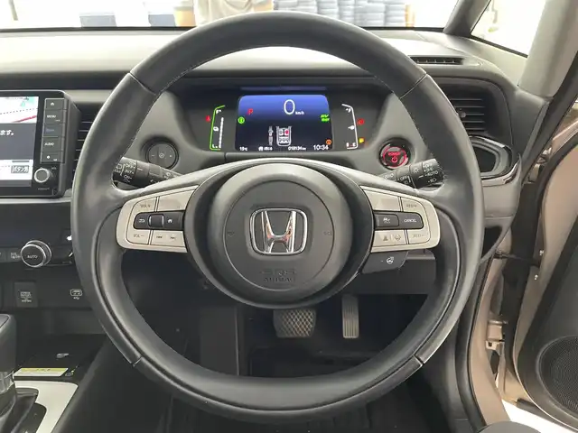 ホンダ フィット e:HEVリュクス 滋賀県 2022(令4)年 1.9万km ゴールド 純正9インチナビ/【Bluetooth/CD/DVD/フルセグTV】/ハーフレザーシート/バックカメラ/追従クルーズコントロール/クリアランスソナー/LEDヘッドライト/オートマチックハイビーム/前後ドライブレコーダー/D/Nシートヒーター/ステアリングヒーター/ビルトインETC/電動パーキングブレーキ/オートブレーキホールド/純正フロアマット/プッシュスタート/スマートキー/ステアリングリモコン