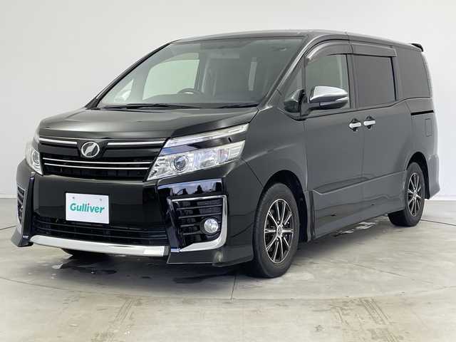 トヨタ ヴォクシー ZS 煌 新潟県 2015(平27)年 8.2万km ブラック 純正9インチディーラーOPナビ（NSZT-Y64T）/　・バックカメラ/　・フルセグTV/　・Bluetooth/　・DVD/SD/CD再生機能/ビルトインETC/両側パワースライドドア/オートライト/オートドアミラー/ウィンカーミラー/社外15インチアルミホイール/純正フロアマット/純正ドアバイザー/アイドリングストップ/プッシュスタート
