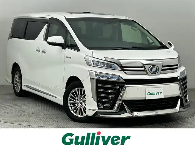 トヨタ ヴェルファイア ハイブリット ZR 道央・札幌 2019(令1)年 6.5万km ホワイトパールクリスタルシャイン ・４WD/・ダブルサンルーフ/・トヨタセーフティセンス/・プリクラッシュセーフティ/・レーンキープアシスト/・レーダークルーズコントロール/・オートハイビーム/・パーキングサポートブレーキ/・リアクロストラフィックアラート/・ロードサインアシスト/・ブラインドスポットモニター/・メーカーナビ/・バックカメラ/フルセグ/BT/CD/DVD/JBL/・フリップダウンモニター/・両側パワースライドドア/・シートヒーター/・シートクーラー/・シートメモリ/・ビルトインETC/・コーナーセンサー/・LEDヘッドライト