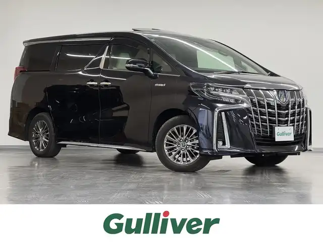 トヨタ アルファードハイブリット エグゼクティブ ラウンジ S 愛知県 2018(平30)年 0.7万km スパークリングブラックパールクリスタルシャイン ハイブリッド/E-Four（4WD）/MTモード付インパネCVT/純正 9.2型ナビ/（AM/FM/CD/DVD/Blu-ray/SDREC/SD/USB/Bluetooth/VTR/AUX/TV/後席モニター操作）/12.1型 後席モニター/パノラミックビューモニター/両側パワースライドドア/ビルトインETC2.0/Toyota Safety Sense/●プリクラッシュセーフティ/●レーントレーシングアシスト/●レーダークルーズ（全車速追従機能付）/●ロードサインアシスト/●アダプティブハイビームシステム/・先行車発進告知/・ブラインドスポットモニター＆リヤクロストラフィックアラート/・インテリジェントクリアランスソナー（PKSB）/・【OP】ITS Connect/装備/・【OP】ツインムーンルーフ/・白革シート/・シートヒーター＆ベンチレーション（D/N/2nd）/・エグゼクティブラウンジシート（D8way/N.2nd8way＋伸縮オットマン）（D.N.2ndメモリー機能付）/・デジタルインナーミラー/・AC100Vコンセントx5（1500W）/・パワーバックドア/・左右独立オートエアコン（前席）＋後席オートエアコン/・オートワイパー/・ステアリングスイッチ/・保/取/・純正17inAW/・予備キーx1