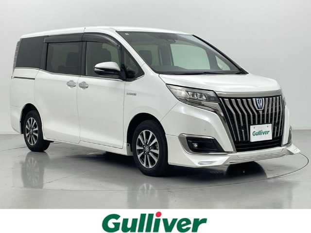 トヨタ エスクァイア ハイブリッド Gi プレミアムパッケージ ブラックテーラード 熊本県 2019(平31)年 6.9万km ホワイトパールクリスタルシャイン 純正１０インチナビ（ＮＳＺＮ－Ｚ６８Ｔ）/フルセグTV/CD/DVD/SD/BT/HDMI/純正フリップダウンモニター/両側パワースライドドア/ETC/純正エアロ/前席シートヒーター/ステアリングヒーター/前後クリアランスソナー/ロールサンシェード/トヨタセーフティーセンス/・プリクラッシュセーフティ/・レーンキープアシスト/・オートハイビーム/・クルーズコントロール/横滑り防止/ハーフレザーシート/純正フロアマット/純正１５インチAW/オートライト/LEDヘッドライト/スマートキー/プッシュスタート/スペアキー1本