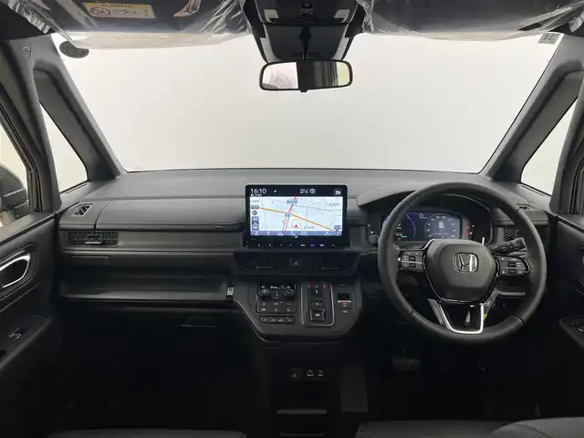 ホンダ ステップワゴン スパーダ eHEV 富山県 2025(令7)年 0.1千km クリスタルブラックパール 純正11.4型ナビ（AM/FM/DVD/BT/USB/フルセグ）/バックカメラ/純正15.6型後席モニター/両側パワースライドドア/パワーバックドア/ハーフレザーシート/D/N席シートヒーター/ブラインドスポットモニター/衝突被害軽減システム/レーダークルーズコントロール/レーンキープアシスト/コーナーセンサー/アイドリングストップ/純正アルミホイール/オートLEDライト/フォグライト/革巻きステアリング/ステアリングスイッチ/パドルシフト/スマートキー/スペアキー