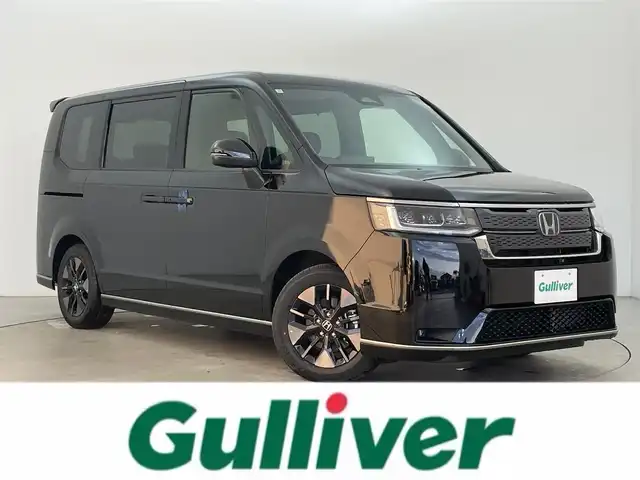 ホンダ ステップワゴン スパーダ eHEV 富山県 2025(令7)年 0.1千km クリスタルブラックパール 純正11.4型ナビ（AM/FM/DVD/BT/USB/フルセグ）/バックカメラ/純正15.6型後席モニター/両側パワースライドドア/パワーバックドア/ハーフレザーシート/D/N席シートヒーター/ブラインドスポットモニター/衝突被害軽減システム/レーダークルーズコントロール/レーンキープアシスト/コーナーセンサー/アイドリングストップ/純正アルミホイール/オートLEDライト/フォグライト/革巻きステアリング/ステアリングスイッチ/パドルシフト/スマートキー/スペアキー