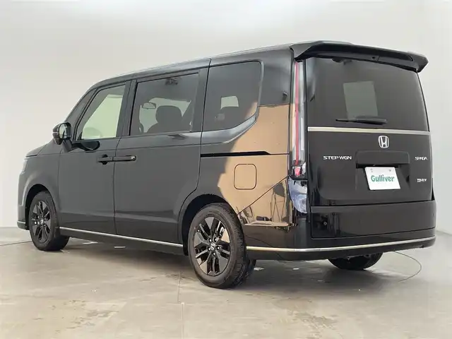 ホンダ ステップワゴン スパーダ eHEV 富山県 2025(令7)年 0.1千km クリスタルブラックパール 純正11.4型ナビ（AM/FM/DVD/BT/USB/フルセグ）/バックカメラ/純正15.6型後席モニター/両側パワースライドドア/パワーバックドア/ハーフレザーシート/D/N席シートヒーター/ブラインドスポットモニター/衝突被害軽減システム/レーダークルーズコントロール/レーンキープアシスト/コーナーセンサー/アイドリングストップ/純正アルミホイール/オートLEDライト/フォグライト/革巻きステアリング/ステアリングスイッチ/パドルシフト/スマートキー/スペアキー