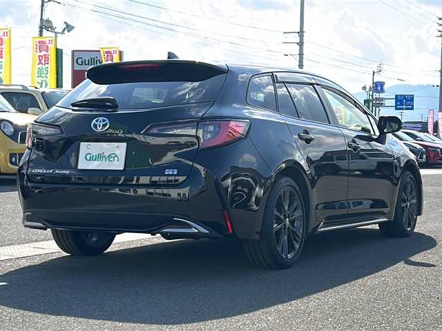 トヨタ カローラツーリング ハイブリッド ダブルバイビー 香川県 2023(令5)年 4.1万km アティチュードブラックマイカ 純正ナビ（フルセグTV/BT)/バックカメラ/ステアリングヒーター/ブラインドスポットモニター/ヘッドライトレベライザー/後退時交差車両検知警報システム/安心降車アシスト/ロードサインアシスト/シートヒーター/コーナーセンサー/オートライト/アイドリングストップ/ビルトインETC2.0