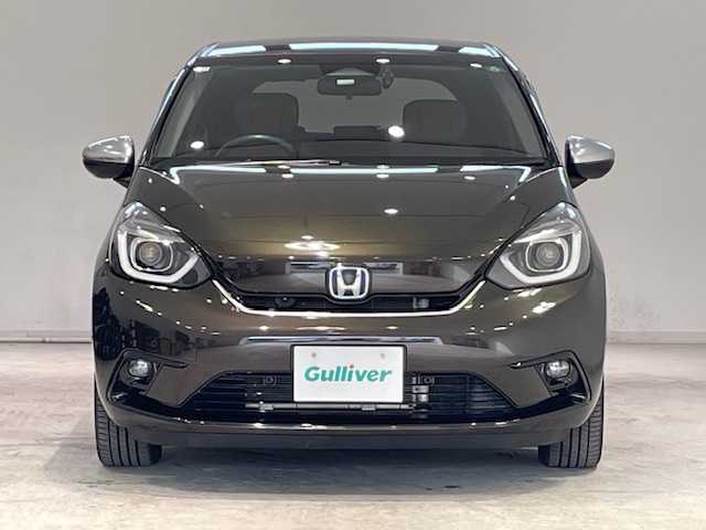 ホンダ フィット e:HEVリュクス 宮城県 2020(令2)年 6.5万km プレミアムグラマラスブロンズP ホンダセンシング/・急アクセル抑制機能/・トラフィックジャムアシスト/・衝突軽減ブレーキ/・先行車発進お知らせ機能/・歩行者事故低減ステアリング/・路外逸脱抑制機能/・渋滞時機能付アダプティブクルーズコントロール/・車線維持支援システム/・オートハイビーム/・誤発進抑制機能/・後方誤発進抑制機能/・近距離衝突軽減ブレーキ/・急アクセル抑制機能/純正ナビ/・フルセグTV/Bluetooth、CD/DVD/・前後コーナーセンサー/・ドライブレコーダー（前後）/シートヒーター/電子パーキング/・ブレーキホールド/純正フロアマット/・純正アルミホイール