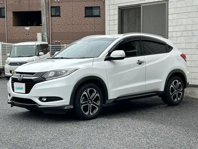 ホンダ ヴェゼル S 福岡県 2014(平26)年 9.8万km ホワイトオーキッドパール 純正メモリナビ【VXM-145VSi】/　(AM/FM/CD/DVD/Bluetooth/ワンセグTV)/バックカメラ/横滑り防止/クルーズコントロール/純正17インチアルミホイール/ルーフレール/電格ウィンカーミラー/ドアバイザー/黒色ハーフレザーシート/パドルシフト/ブレーキホールド/シートヒーター/アイドリングストップ/ETC/フロントガラス熱線スイッチ/保証書/ナビ取扱説明書