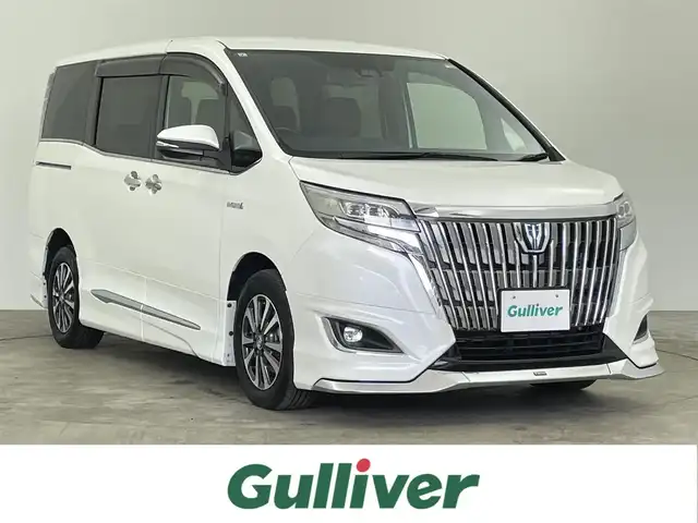 トヨタ エスクァイア ハイブリッド Gi プレミアムパッケージ 千葉県 2017(平29)年 6.2万km ホワイトパールクリスタルシャイン 禁煙車/トヨタセーフティセンス/・プリクラッシュセーフティ/・レーントレーシングアシスト/・クルーズコントロール/・オートマチックハイビーム/・レーンディパーチャーアラート/・プロアクティブドライビングアシスト/・緊急時操舵支援/両側パワースライドドア/フリップダウンモニター/純正10インチナビ/CD/DVD/Bluetooth/フルセグ/バックカメラ/クルーズコントロール/LEDオートライト/ハーフレザーシート/シートヒーター/純正15インチアルミホイール/純正フロアマット/USBポート/プッシュスタート/スマートキー