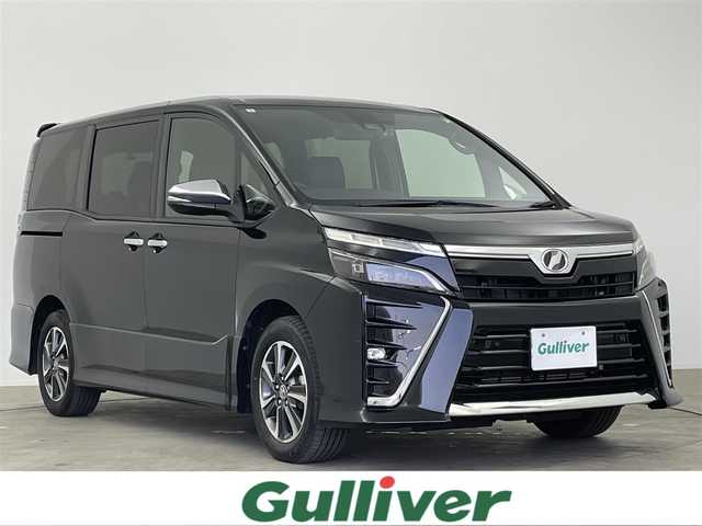 トヨタ ヴォクシー ZS 煌Ⅱ 大分県 2019(令1)年 7.4万km ブラック ワンオーナー/7人乗り/TOYOTAセーフティセンス/・プリクラッシュセーフティ/・レーンディパーチャアラート/・オートマチックハイビーム/純正10型ナビ　型式：NSZN-Z68T/・フルセグTV、DVD再生可、Bluetoorh/・USB、HDMI、AM/FM、CD/ステアリングスイッチ/バックカメラ/純正フリップダウンモニター/　型式：V12T-R68C/両側電動スライドドア/前後ドライブレコーダー/ビルトインETC2.0/革調シートカバー/社外ツィーター/アイドリングストップ/横滑り防止装置/電動格納ミラー/純正フロアマット/オートライト/LEDヘッドライト/LEDフォグ/クリアランスソナー /純正16インチアルミホイール/スペアタイヤ/保証書、取説、スペアキー有り
