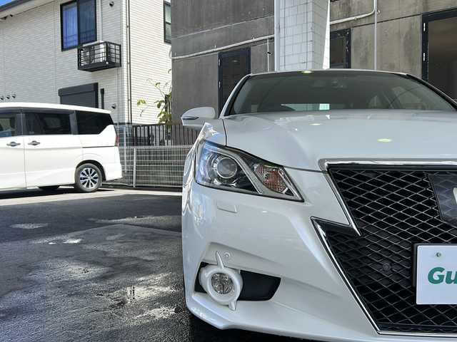トヨタ クラウン ハイブリッド アスリートG 京都府 2014(平26)年 9.4万km ホワイトパールクリスタルシャイン 純正メモリナビ　/フルセグＴＶ　/Bluetooth/CD再生機能有/USB/黒本革シート/D席ポジションメモリー/前席パワーシート　/前席シートヒーター/エアシート　/ベンチシート　/サイドエアロ　/禁煙車　/バックカメラ　/前後コーナーセンサー　/キセノンヘッドライト/フロントフォグランプ/ウィンカーミラー　/クルコン追従有　/純正AW18インチ/純正ビルトインETC/横滑り防止装置/盗難防止装置/衝突被害軽減ブレーキ/Wサイドエアバッグ/カーテンエアバッグ