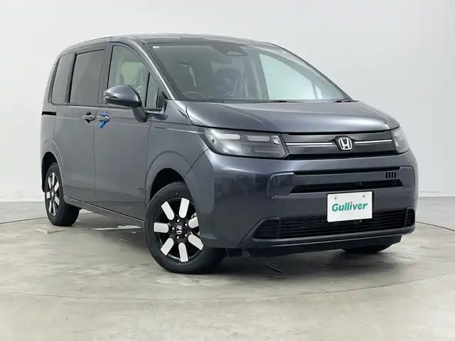 ホンダ フリード ハイブリット e:HEV AIR EX 新潟県 2025(令7)年 0.1千km メテオロイドグレーメタリック 4WD/純正9インチメモリナビ【LXM-242ZFNI】/　フルセTV/Bluetooth/AppleCarPlay/AndroidAuto/ブラインドスポットインフォメーション/踏み間違い衝突軽減システム/レーダークルーズコントロール/衝突被害軽減ブレーキ/レーンキープアシスト/前後コーナーセンサー/両側パワースライドドア/前席シートヒーター/バックモニター/リアクーラー/横滑り防止装置/LEDヘッドライト/オートマチックハイビーム/オートライト/レザーステアリング/ステアリングスイッチ/禁煙車