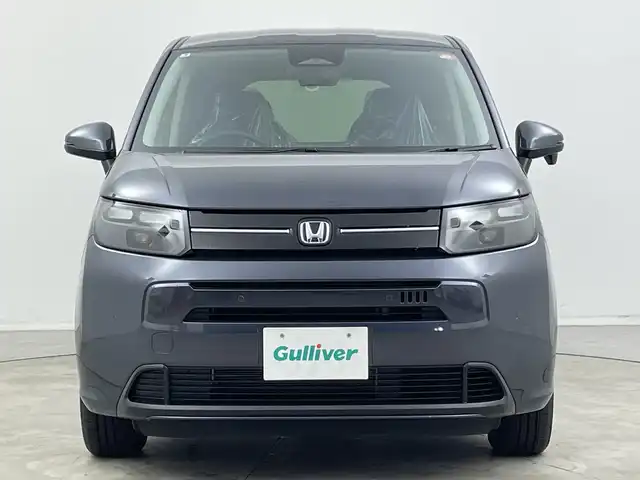 ホンダ フリード ハイブリット e:HEV AIR EX 新潟県 2025(令7)年 0.1千km メテオロイドグレーメタリック 4WD/純正9インチメモリナビ【LXM-242ZFNI】/　フルセTV/Bluetooth/AppleCarPlay/AndroidAuto/ブラインドスポットインフォメーション/踏み間違い衝突軽減システム/レーダークルーズコントロール/衝突被害軽減ブレーキ/レーンキープアシスト/前後コーナーセンサー/両側パワースライドドア/前席シートヒーター/バックモニター/リアクーラー/横滑り防止装置/LEDヘッドライト/オートマチックハイビーム/オートライト/レザーステアリング/ステアリングスイッチ/禁煙車