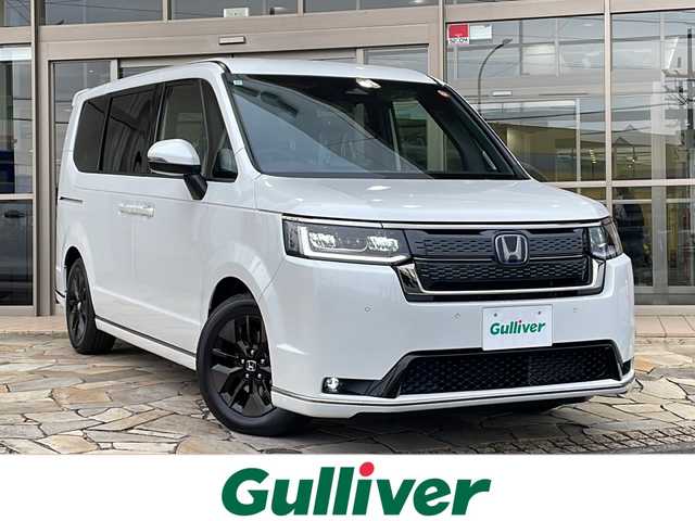 ホンダ ステップワゴン スパーダ eHEV 静岡県 2025(令7)年 0.1千km プラチナホワイトパール 純正メモリナビ/・CD/・DVD/・フルセグＴＶ/・Bluetooth/・USB/・HDMI/・AM/・FM/主要装備/・両側パワスラ/・後席モニター/・衝突軽減/・レーンキープ/・追従クルコン/・BSM/・コーナーセンサー前後/・バックカメラ/・パワーバックドア/・ハーフレザーシート/・シートヒーターD/N席/・パドルシフト/・ステリモ/・電動パーキングブレーキ/・オートホールド/・LEDヘッドライト/・オートライト/・オートハイビーム/・フォグランプ/・純正アルミホイール