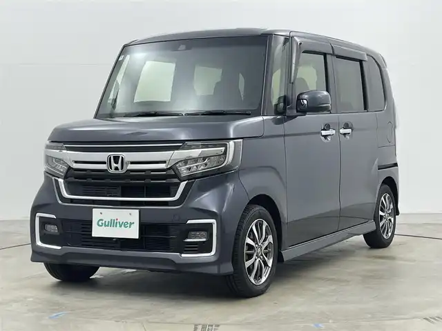ホンダ Ｎ ＢＯＸ カスタム L 岡山県 2022(令4)年 2.1万km メテオロイドグレーメタリック 9インチフローティングナビ/（MDV-M909HDF）/・FM/AM/Bluetooth/フルセグ/CD/DVD/HDMI/バックカメラ/・フロントカメラ/シートヒーター/片側パワースライドドア/ホンダセンシング/・衝突軽減ブレーキ/・車線逸脱警報/・アダプティブクルーズコントロール/・オートハイビーム/・バックソナー/純正フロアマット/LEDヘッドライト/純正アルミ/後席サンシェード/シートバックテーブル/新車保証書/取扱説明書/スペアキー×１