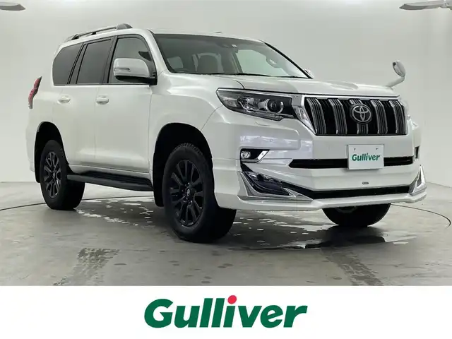 トヨタ ランドクルーザー プラド TX 福井県 2023(令5)年 1.7万km ホワイトパールクリスタルシャイン ・4WD/・サンルーフ/・ルーフレール/・モデリスタエアロ/・ブラックエディション用18インチAW/・トヨタセーフティセンス/・プリクラッシュセーフティ/・レーダークルーズコントロール/・社外9インチSDナビ/(DVD.CD.SD.Bluetooth.フルセグTV)/・バックカメラ/・LEDオートライト/オートハイビーム/・ETC/・トノカバー/・スペアキー×1/・取説/保証書