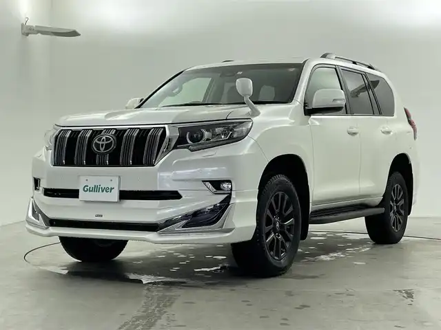 トヨタ ランドクルーザー プラド TX 福井県 2023(令5)年 1.7万km ホワイトパールクリスタルシャイン ・4WD/・サンルーフ/・ルーフレール/・モデリスタエアロ/・ブラックエディション用18インチAW/・トヨタセーフティセンス/・プリクラッシュセーフティ/・レーダークルーズコントロール/・社外9インチSDナビ/(DVD.CD.SD.Bluetooth.フルセグTV)/・バックカメラ/・LEDオートライト/オートハイビーム/・ETC/・トノカバー/・スペアキー×1/・取説/保証書
