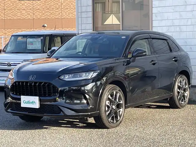 ホンダ ＺＲ－Ｖ ハイブリッド e:HEV Z 福岡県 2024(令6)年 0.6万km クリスタルブラックパール ワンオーナー/BOSEプレミアムサウンド/純正9インチディスプレイオーディオ/　(AM/FM/Bluetooth/フルセグTV/ナビ)/マルチビューカメラ/バック/フロント/サイドカメラ/ホンダセンシング/・衝突軽減ブレーキ/・踏み間違い衝突軽減/・路外逸脱抑制/・歩行者事故低減ステアリング/・先行車発進お知らせ/・標識認識/・オートハイビーム/・アダプティブドライビングビーム/・ブラインドスポットインフォメーション/・パーキングセンサー/・アダプティブクルーズコントロール(渋滞追従機能付)/・車線維持支援/・トラフィックジャムアシスト/横滑り防止/ヒルディセントコントロール/純正18インチアルミホイール/パワーバックドア/パドルシフト/革巻きステアリング/ステアリングスイッチ/ステアリングヒーター/茶色レザーシート/シートメモリー(D)/シートヒーター付きパワーシート(D/N)/コムテック前後ドライブレコーダー【AG425-DRC】/純正ナビ連動型ビルトインETC2.0/純正フロアマット/置くだけ充電/USB端子、タイプC端子/ISOFIX/スペアキー×1/保証書/取扱説明書/ナビ取扱説明書