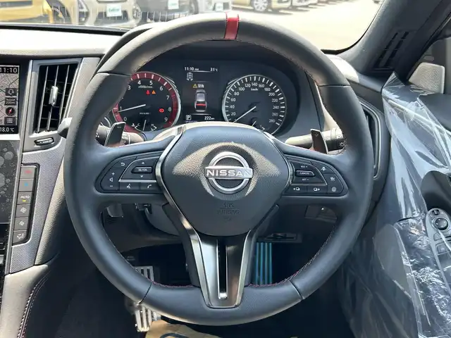 日産 スカイライン ニスモ 愛知県 2023(令5)年 0.1万km グレー ワンオーナー/HDDナビ/フルセグテレビ/バックカメラ（全方位）/クルーズコントロール（追従走行あり）/ドアバイザー/サンルーフ/プッシュスタート/ETC2.0/パドルシフト/クリアランスソナー/コーナリングランプ/純正フロアマット/フォグランプ/カラーコードKCE/AM/FM/USB/BT/TV/NISMO専用バンパー〈フロント・リヤ〉/ NISMO専用LEDフォグランプ〈フロント・リヤ〉/ NISMO専用サイドシルプロテクター/ NISMO専用エンブレム〈フロント・リヤ〉/ NISMO専用GTエンブレム〈サイド〉/NISMO専用タイヤ（DUNLOP SP SPORT MAXX GT 600）/NISMO専用エンケイ製19インチアルミホイール/シートヒーターD+N席