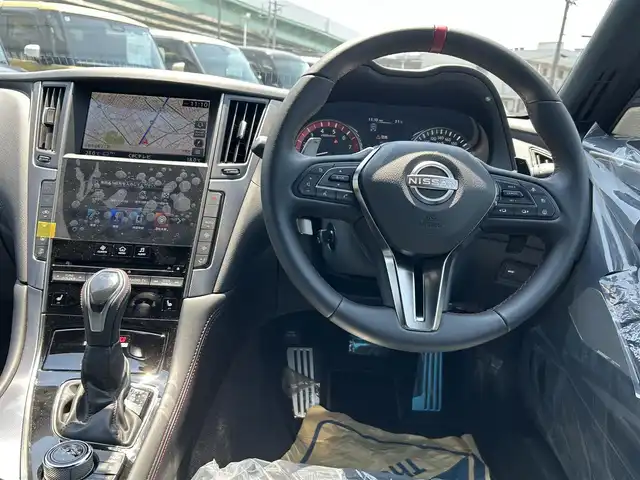 日産 スカイライン ニスモ 愛知県 2023(令5)年 0.1万km グレー ワンオーナー/HDDナビ/フルセグテレビ/バックカメラ（全方位）/クルーズコントロール（追従走行あり）/ドアバイザー/サンルーフ/プッシュスタート/ETC2.0/パドルシフト/クリアランスソナー/コーナリングランプ/純正フロアマット/フォグランプ/カラーコードKCE/AM/FM/USB/BT/TV/NISMO専用バンパー〈フロント・リヤ〉/ NISMO専用LEDフォグランプ〈フロント・リヤ〉/ NISMO専用サイドシルプロテクター/ NISMO専用エンブレム〈フロント・リヤ〉/ NISMO専用GTエンブレム〈サイド〉/NISMO専用タイヤ（DUNLOP SP SPORT MAXX GT 600）/NISMO専用エンケイ製19インチアルミホイール/シートヒーターD+N席