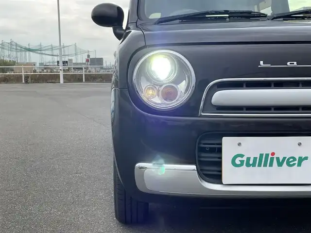 スズキ ラパン ショコラ G 佐賀県 2015(平27)年 1万km アーバンブラウンパールメタリック 社外SDナビゲーション/・ワンセグTV/AM/FM/CD/アイドリングストップ/ブラウンレザーシート(合皮)/ISOFIX対応/プッシュスタート/スマートキー/革巻きステアリング/純正キセノンヘッドライト/ドアバイザ―/取扱説明書/スペアキー１本