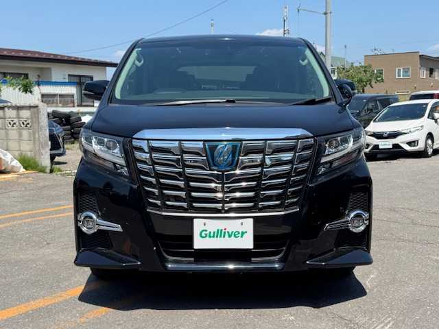 トヨタ アルファードハイブリット SR 道東・釧路十勝 2015(平27)年 9.6万km ブラック 4WD/純正メモリーナビ/　　（DVD/CD/フルセグTV/Bluetooth）/バックカメラ/純正フリップダウンモニター/衝突軽減ブレーキ/レーダークルーズコントロール/パワーバックドア/前席パワーシート/両側パワースライドドア/ハーフレザーシート/ウッドコンビハンドル/ステアリングリモコン/横滑り防止装置/LEDヘッドライト/フォグライト/ウィンカーミラー/電動格納ミラー/オットマンシート（助手席/2列目）/ドライブレコーダー/ビルトインETC/JBLサウンドシステム/ドアバイザー/純正フロアマット/スマートキー/エンジンプッシュスタート/スペアキー/取扱説明書/保証書/ナビ取説/純正17インチアルミホイール/冬タイヤ積み込み/　　（215/65R16、３mm、社外AW）