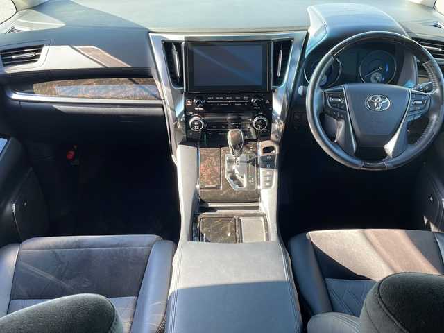 トヨタ アルファードハイブリット SR 道東・釧路十勝 2015(平27)年 9.6万km ブラック ・4WD/・純正9インチメモリナビ/（DVD・CD・フルセグ・Bluetooth・ラジオ・SD）/・バックカメラ/・純正10インチフリップダウンモニター/・JBLサウンドシステム/・衝突軽減ブレーキ/・レーダークルーズコントロール/・パワーバックドア/・前席パワーシート/・両側パワースライドドア/・ハーフレザーシート/・ウッドコンビハンドル/・ステアリングリモコン/・横滑り防止装置/・HIDヘッドライト/・フォグライト/・ウィンカーミラー/・電動格納ミラー/・オットマンシート（助手席/2列目）/・ドライブレコーダー/・ビルトインETC/・ドアバイザー/・純正フロアマット/・スマートキー/・エンジンプッシュスタート/・純正17インチアルミホイール