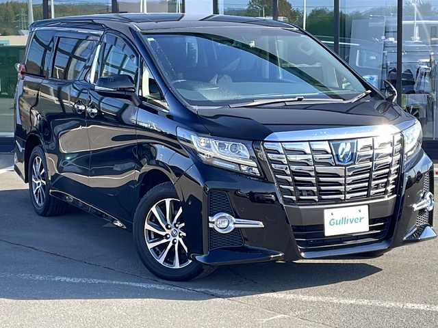 トヨタ アルファードハイブリット SR 道東・釧路十勝 2015(平27)年 9.6万km ブラック ・4WD/・純正9インチメモリナビ/（DVD・CD・フルセグ・Bluetooth・ラジオ・SD）/・バックカメラ/・純正10インチフリップダウンモニター/・JBLサウンドシステム/・衝突軽減ブレーキ/・レーダークルーズコントロール/・パワーバックドア/・前席パワーシート/・両側パワースライドドア/・ハーフレザーシート/・ウッドコンビハンドル/・ステアリングリモコン/・横滑り防止装置/・HIDヘッドライト/・フォグライト/・ウィンカーミラー/・電動格納ミラー/・オットマンシート（助手席/2列目）/・ドライブレコーダー/・ビルトインETC/・ドアバイザー/・純正フロアマット/・スマートキー/・エンジンプッシュスタート/・純正17インチアルミホイール