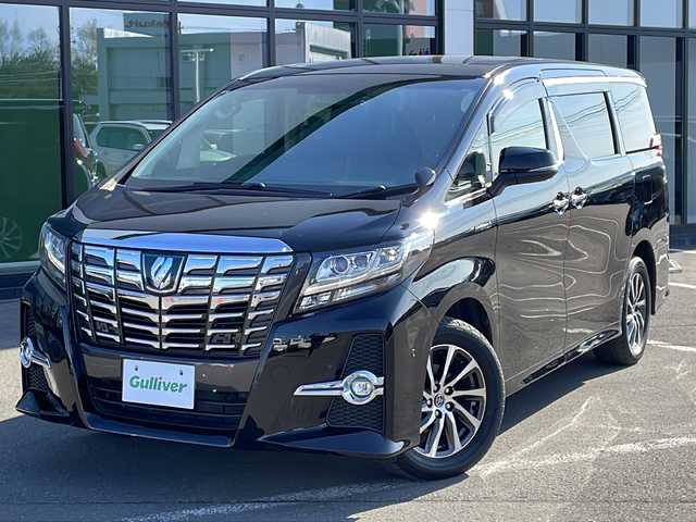 トヨタ アルファードハイブリット SR 道東・釧路十勝 2015(平27)年 9.6万km ブラック ・4WD/・純正9インチメモリナビ/（DVD・CD・フルセグ・Bluetooth・ラジオ・SD）/・バックカメラ/・純正10インチフリップダウンモニター/・JBLサウンドシステム/・衝突軽減ブレーキ/・レーダークルーズコントロール/・パワーバックドア/・前席パワーシート/・両側パワースライドドア/・ハーフレザーシート/・ウッドコンビハンドル/・ステアリングリモコン/・横滑り防止装置/・HIDヘッドライト/・フォグライト/・ウィンカーミラー/・電動格納ミラー/・オットマンシート（助手席/2列目）/・ドライブレコーダー/・ビルトインETC/・ドアバイザー/・純正フロアマット/・スマートキー/・エンジンプッシュスタート/・純正17インチアルミホイール