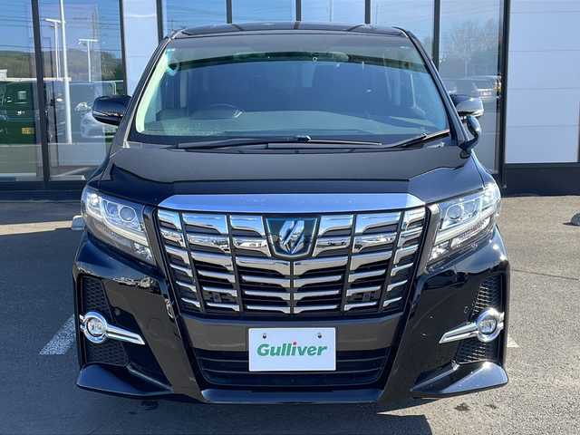 トヨタ アルファードハイブリット SR 道東・釧路十勝 2015(平27)年 9.6万km ブラック ・4WD/・純正9インチメモリナビ/（DVD・CD・フルセグ・Bluetooth・ラジオ・SD）/・バックカメラ/・純正10インチフリップダウンモニター/・JBLサウンドシステム/・衝突軽減ブレーキ/・レーダークルーズコントロール/・パワーバックドア/・前席パワーシート/・両側パワースライドドア/・ハーフレザーシート/・ウッドコンビハンドル/・ステアリングリモコン/・横滑り防止装置/・HIDヘッドライト/・フォグライト/・ウィンカーミラー/・電動格納ミラー/・オットマンシート（助手席/2列目）/・ドライブレコーダー/・ビルトインETC/・ドアバイザー/・純正フロアマット/・スマートキー/・エンジンプッシュスタート/・純正17インチアルミホイール