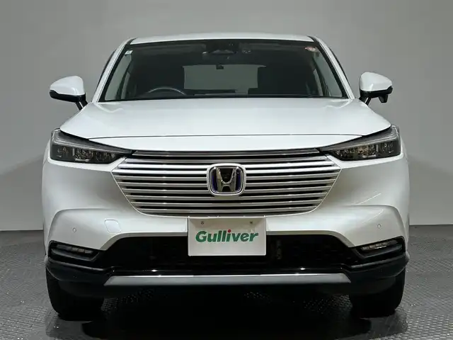 ホンダ ヴェゼル ハイブリッド e:HEV Z 愛媛県 2024(令6)年 2.6万km プラチナホワイトパール メーカーナビ/(Bluetooth/フルセグ)/バックカメラ/衝突被害軽減ブレーキ/レーンキープアシスト/前後コーナーセンサー/電動リアゲート/前後ドライブレコーダー/レーダークルーズコントロール/ダウンヒルアシストコントロール/ステアリングヒーター/シートヒーター/ETC2.0/ステアリングスイッチ/ワイヤレス充電/ブラインドスポットモニター/パドルシフト/LEDヘッドライト/オートマチックハイビーム/オートライト/トノカバー/ドアバイザー/スペアキー/保証書