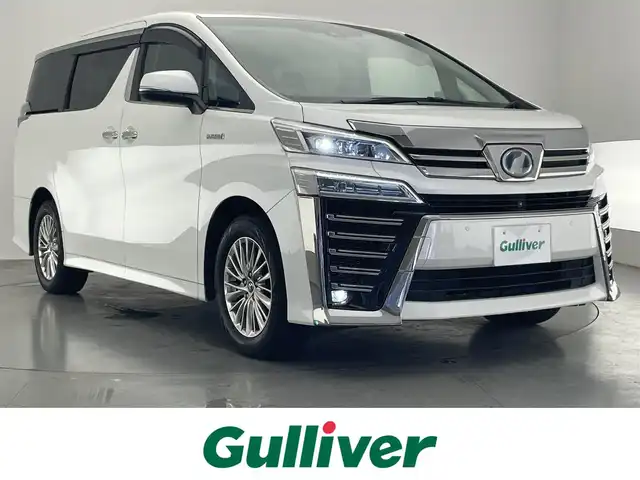 トヨタ ヴェルファイア ハイブリット ZR Gエディション 愛知県 2019(平31)年 6.2万km ホワイトパールクリスタルシャイン 純９型ナビ　フルセグＴＶ　全方位カメラ　ＪＢＬサウンド　デジタルインナーミラー　純１２型後席モニター　パワーバックドア　両側電動スライドドア　温・冷シート　黒革　３眼ＬＥＤオートライト　ＢＳＭ　禁煙車/ETC２．０　ドラレコ　1・2列目シートヒーター　オートハイビーム　追従クルコン　衝突軽減　メモリ付きパワーシート　オットマン　Bluetooth　HDMI端子　後席エアコン