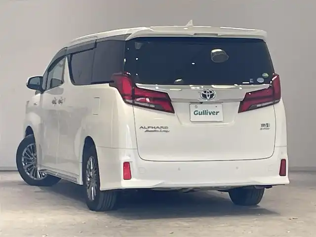 トヨタ アルファードハイブリット エグゼクティブ ラウンジ S 宮城県 2020(令2)年 4.1万km ホワイトパールクリスタルシャイン 4WD/ツインムーンルーフ/JBLサウンドシステム/トヨタセーフティセンス/・プリクラッシュセーフティ/・レーントレーシングアシスト/・クリアランスソナー/・パーキングサポートブレーキ/・ブラインドスポットモニター/・リヤクロストラフィックアラート/・ロードサインアシスト/純正ナビ/・フルセグTV/Bluetooth/CD/DVD/・純正フリップダウン/・純正ビルドインETC2.0/・ドライブレコーダー前方/・デジタルインナーミラー/・全方位カメラ/電子パーキング/・オートブレーキホールド/電動リアゲート/革巻きステアリング/・ステアリングスイッチ/レザーシート/・シートメモリー(運転席)/・シートヒーター（全席）/・オットマン（助手席・2列目）/AC100V充電/プッシュスタート/・スマートキー/LEDヘッドライト/・オートライト/・オートマチックハイビーム/・フォグランプ/純正アルミホイール/純正フロアマット/ドアバイザー