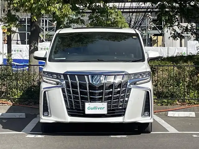 トヨタ アルファードハイブリット エグゼクティブ ラウンジ S 宮城県 2020(令2)年 4.1万km ホワイトパールクリスタルシャイン 4WD/ツインムーンルーフ/JBLサウンドシステム/トヨタセーフティセンス/・プリクラッシュセーフティ/・レーントレーシングアシスト/・クリアランスソナー/・パーキングサポートブレーキ/・ブラインドスポットモニター/・リヤクロストラフィックアラート/・ロードサインアシスト/純正ナビ/・フルセグTV/Bluetooth/CD/DVD/・純正フリップダウン/・純正ビルドインETC2.0/・ドライブレコーダー前方/・デジタルインナーミラー/・全方位カメラ/電子パーキング/・オートブレーキホールド/電動リアゲート/革巻きステアリング/・ステアリングスイッチ/レザーシート/・シートメモリー(運転席)/・シートヒーター（全席）/・オットマン（助手席・2列目）/AC100V充電/プッシュスタート/・スマートキー/LEDヘッドライト/・オートライト/・オートマチックハイビーム/・フォグランプ/純正アルミホイール/純正フロアマット/ドアバイザー