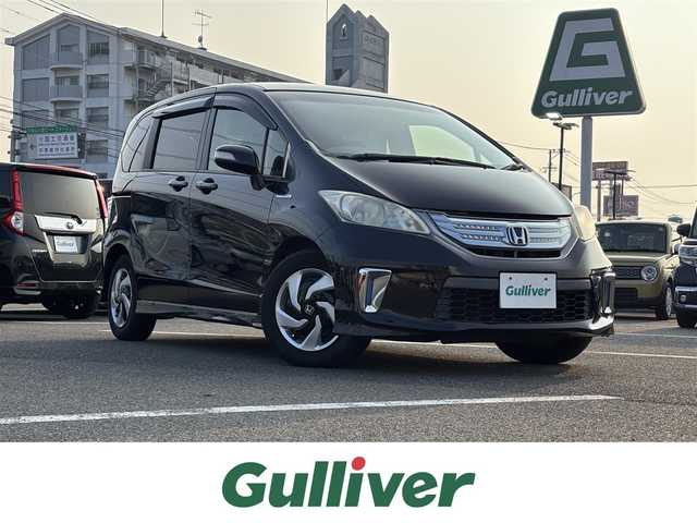 ホンダ フリード ハイブリット ジャストセレクション 大分県 2011(平23)年 6.5万km プレミアムブラキッシュパール ・純正ナビ(CD.DVD.SD.BT)/・フルセグテレビ/・片側パワースライドドア/・後席モニター/・三列シート/・ETC/・オートエアコン/・オートライト/・スマートキー/・クルーズコントロール/・ステアリングリモコン/・フロアマット