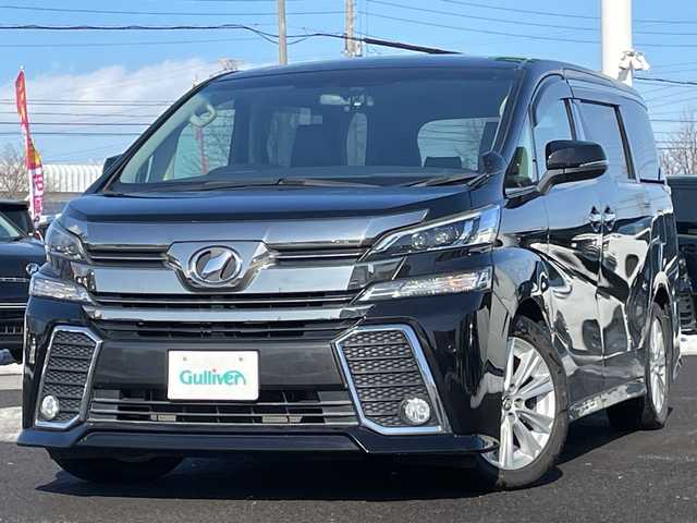 トヨタ ヴェルファイア Z 道央・札幌 2015(平27)年 5.9万km バーニングブラッククリスタルシャインガラスフレーク ４WD/社外メモリーナビ/AM/FM/BT/CD/DVD/SD/フルセグ/横滑り防止装置/クリアランスソナー/バックカメラ/ビルトインETC/ドライブレコーダー/アイドリングストップ/ECOMODE/両側パワースライドドア/オットマン/レザー調シートカバー/革巻きステアリング/ステアリングリモコン/電動パーキング/ブレーキホールド/MTモード付AT/プッシュスタート/スマートキー/LEDヘッドライト/オートライト/フォグランプ/電動格納ミラー/ウィンカーミラー/社外フロアマット/ドアバイザー/スペアキー