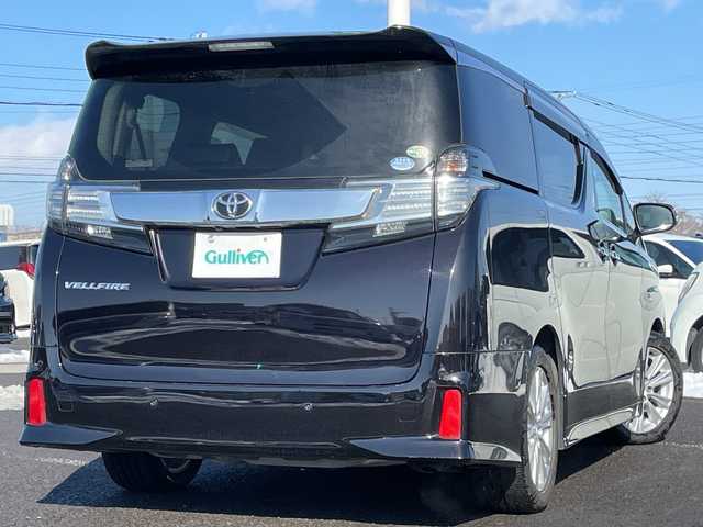 トヨタ ヴェルファイア Z 道央・札幌 2015(平27)年 5.9万km バーニングブラッククリスタルシャインガラスフレーク ４WD/社外メモリーナビ/AM/FM/BT/CD/DVD/SD/フルセグ/横滑り防止装置/クリアランスソナー/バックカメラ/ビルトインETC/ドライブレコーダー/アイドリングストップ/ECOMODE/両側パワースライドドア/オットマン/レザー調シートカバー/革巻きステアリング/ステアリングリモコン/電動パーキング/ブレーキホールド/MTモード付AT/プッシュスタート/スマートキー/LEDヘッドライト/オートライト/フォグランプ/電動格納ミラー/ウィンカーミラー/社外フロアマット/ドアバイザー/スペアキー
