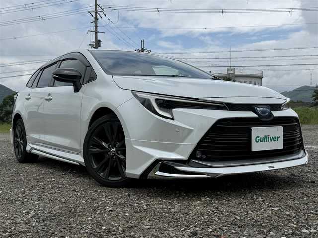 トヨタ カローラツーリング ハイブリッド ダブルバイビー 兵庫県 2022(令4)年 1.1万km プラチナホワイトパールマイカ ワンオーナー/モデリスタエアロ（F/S/RU）/TRDテールゲートスポイラー/純正10インチナビ/フルセグTV/バックモニター/ETC2.0/ハーフレザーシート/LEDヘッドライト/オートハイビーム/レーダークルコン/レーンキープ