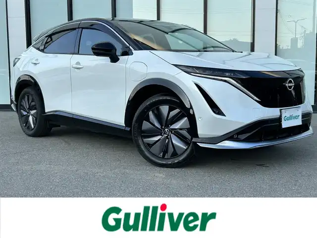 日産 アリア B6 大阪府 2023(令5)年 1.7万km パールⅡ 純正12.3インチコネクトナビ/　（AppleCarPlay/AndroidAuto/フルセグTV/USB/Bluetooth）/パノラミックガラスルーフ　/プロパイロット2.0/ハーフレザーシート/　（D席パワーシート/全席シートヒーター）　/ステアリングヒーター　/前後ドライブレコーダー　/全方位モニター　/パワーバックドア/レーダークルーズコントロール/ブラインドスポットミラー/ヘッドアップディスプレイ/デジタルインナーミラー/ＥＴＣ2.0　/ハーフレザーシート　/純正19インチアルミホイール/純正フロアマット/ワイヤレス充電/LEDヘッドライト/充電ケーブルなし