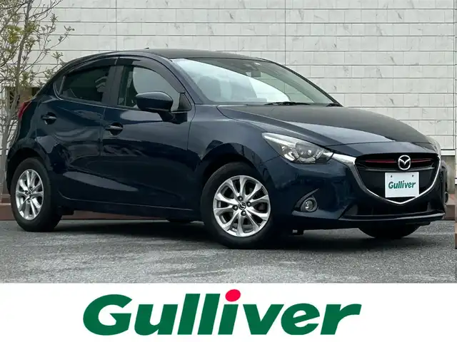 マツダ デミオ XD 滋賀県 2015(平27)年 5.4万km ディープクリスタルブルーマイカ ディーゼル/2WD(FF)/6速MT/7インチ純正ナビ/（FM/AM/CD/DVD/フルセグ/Bluetooth）/ETC/ドライブレコーダー/バックカメラ/プリクラッシュブレーキアシスト	/クルーズコントロール/レーンキープアシスト	/電動格納ミラー/アイドリングストップ/ステアリングスイッチ/オートライト/LEDヘッドライト/フロントフォグ/フルオートエアコン/プッシュスタート/スマートキー/純正フロアマット/ドアバイザー