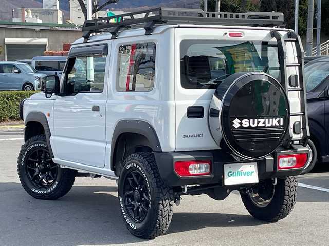 スズキ ジムニー XG 長野県 2023(令5)年 2.7万km スペリアホワイト 禁煙車/4WD/10インチフローティングマルチオーディオ/Bluetooth/社外スロットルコントローラー/グリルガード/オーバーフェンダー/背面タイヤカバー/1.5インチリフトアップキット/ルーフラック/リアラダー/純正足回り車載/ETC/純正アルミホイール/ダウンヒルアシスト/フォグランプ/LEDヘッドライト/オートライト/横滑り防止装置/ABS/ドアバイザー/リモコンキー/アイドリングストップ/パワーウインドウ/パワーステアリング/新車時保証書/取扱説明書
