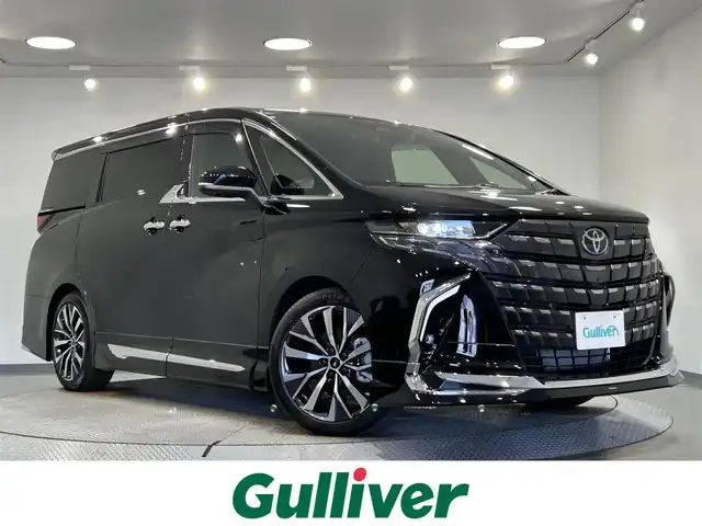 トヨタ アルファードハイブリット Z 愛知県 2024(令6)年 0.1万km ブラック 純正１４インチディスプレイオーディオ/純正13.2インチフリップダウンモニター/左右独立ムーンルーフ/モデリスタエアロ/モデリスタ２０インチアルミホイール/パノラミックビューモニター/レーダークルーズコントロール/後席用パワーサイドサンシェード/パワーバックドア/両側パワースライドドア/ワイヤレス充電/ハンドルヒーター/シートヒーター＆シートクーラー/シートメモリー/デジタルインナーミラー/前後ドライブレコーダー/ビルトインETC2.0/USB＆HDMI入力端子/プリクラッシュセーフティ/レーンディパーチャーアラート/プロアクティブドライビングアシスト/ブラインドスポットモニター/クリアランスソナー
