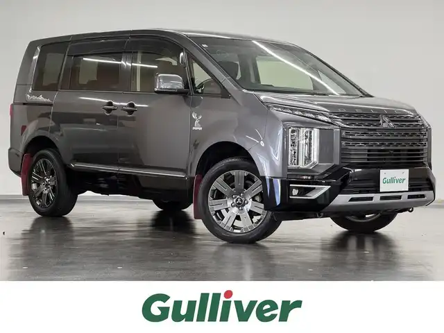 三菱 デリカＤ：５ ジャスパー 三重県 2020(令2)年 2.4万km アイガーグレーM/ダイヤモンドブラックマイカ ディーゼル・ターボ/フルタイム4WD/MTモード付インパネ8AT/純正 10.1インチナビ QY9000MC/（FM/AM/TV/Music Catcher/Bluetooth/CD/DVD/SD/USB/iPod/HDMI/AUX）/11.5インチ 純正 後席フリップダウンモニター［ALPINE製］/マルチアラウンドモニター/両側オートスライドドア/e-Assist/・衝突被害軽減ブレーキシステム/・車線逸脱警報システム/・レーダークルーズコントロールシステム/・オートハイビーム/・誤発進抑制機能（前進時）/・後側方車両検知警報システム（レーンチェンジアシスト機能付）［BSW/LCA］/・後退時交差車両検知警報システム［RCTA］/装備/・ハーフレザーシート/・パワーシート（D6way）/・左右独立オートエアコン/・後席クーラー＆ヒーター/・AC100V電源コンセント（100W）/・オートライト/・LED ヘッドランプ＋フロントフォグランプ/・パドルシフト/・純正18inAW/・プッシュスタート/・保/取/・スマートキーx2/など