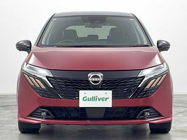 日産 オーラ G  90周年記念車 群馬県 2024(令6)年 0.2万km ガーネットレッド/スーパーブラック 2トーン 純正９型ナビ　全周囲カメラ　ＢＯＳＥサウンド　電子ミラー　ワイヤレス充電器　プロパイロット　アダプティブクルーズコントロール　ドラレコ　純正アルミホイール　オートブレーキホールド　ＬＥＤライト　禁煙